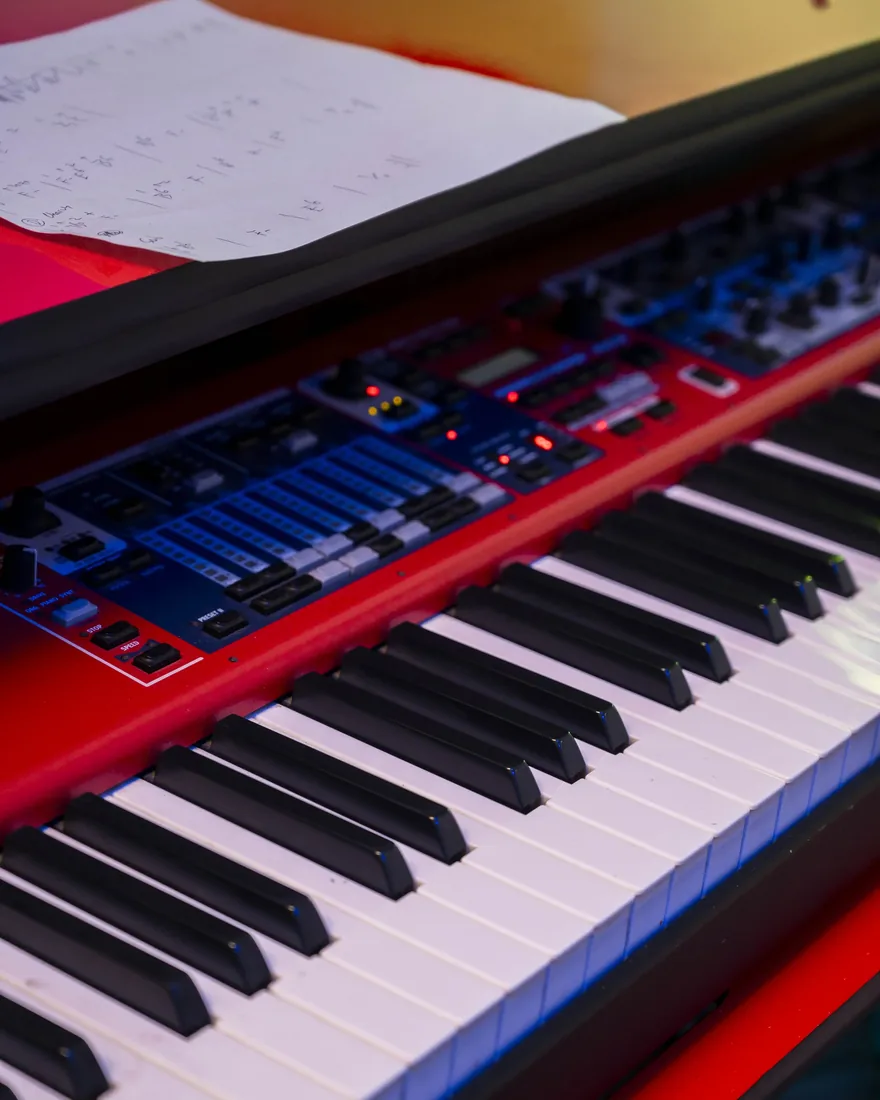 A stage piano and sheet music in the studio